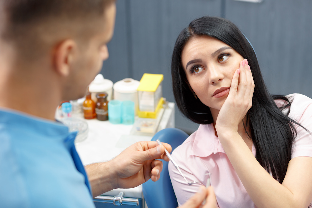 woman showing dental pain