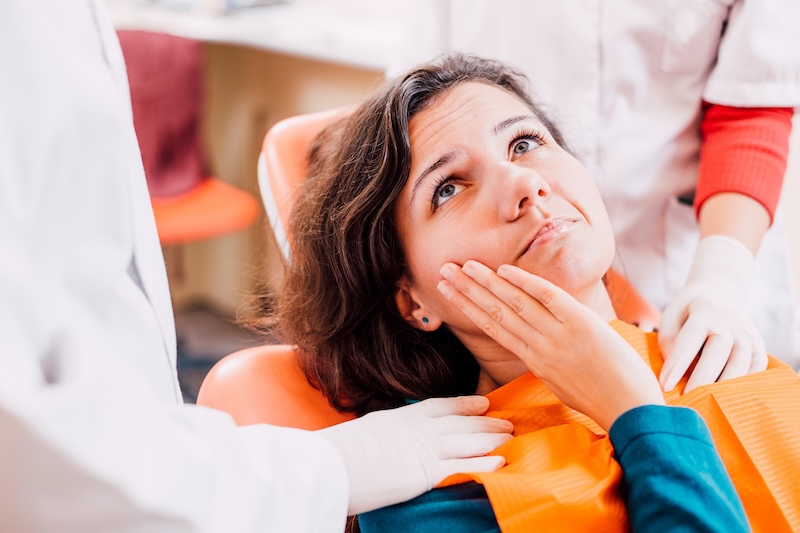 lady showing tooth pain