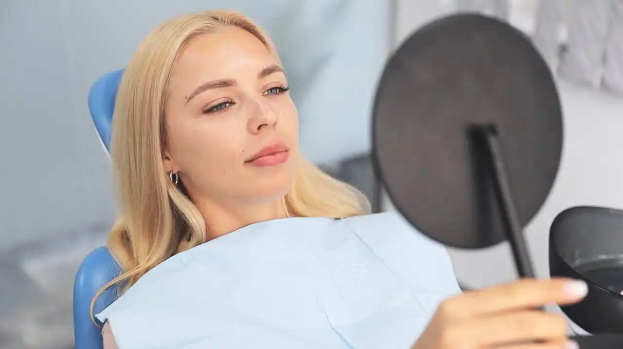 Lady looking at a mirror with a new smile